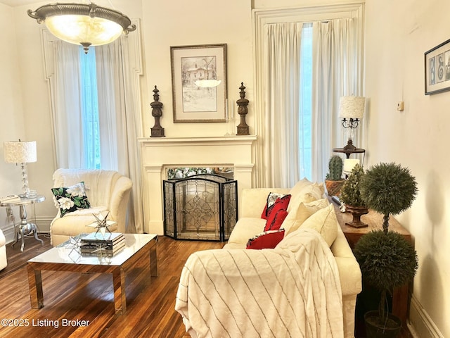 218 Locust St, Jeffersonville, IN 47130 - living area with a fireplace, wood finished floors, and baseboards