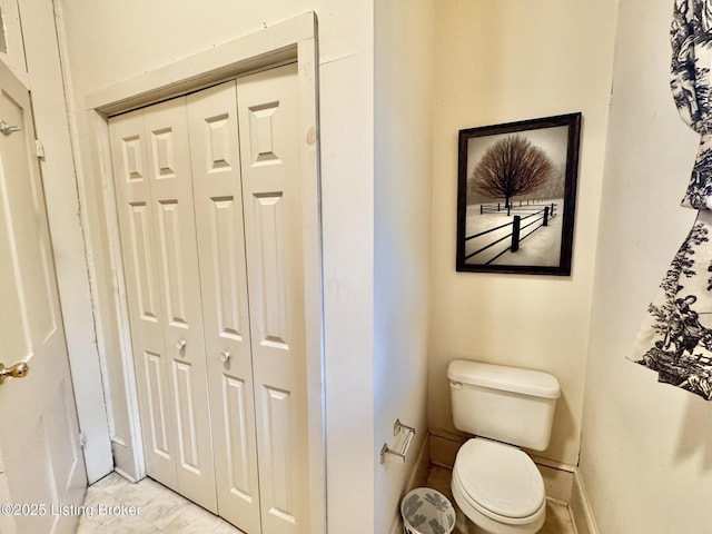 218 Locust St, Jeffersonville, IN 47130 - bathroom featuring toilet, a closet, and marble finish flooring