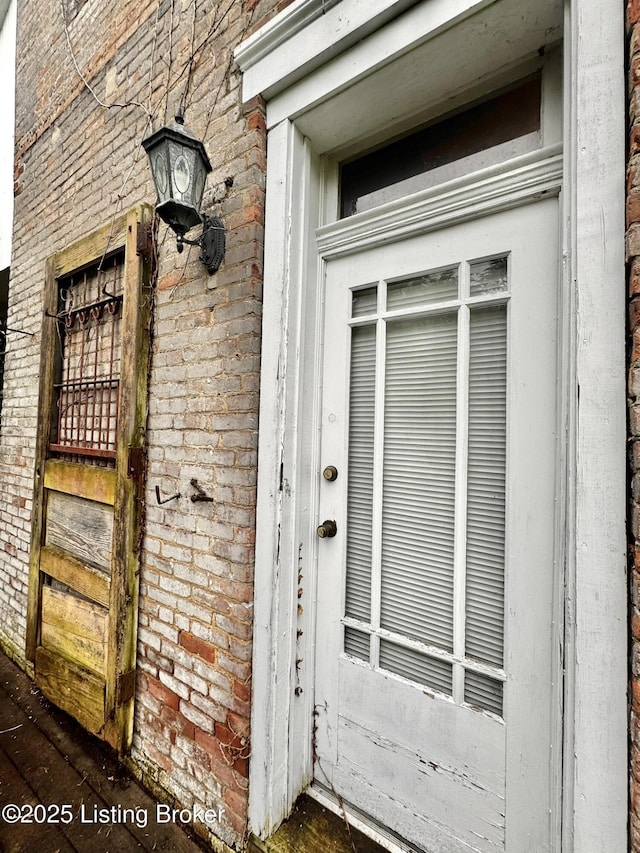 218 Locust St, Jeffersonville, IN 47130 - doorway to property featuring brick siding