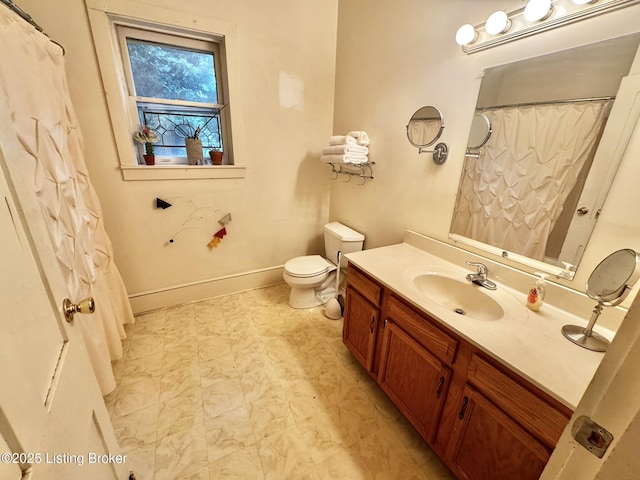 218 Locust St, Jeffersonville, IN 47130 - bathroom with vanity, toilet, marble look tiles, baseboards, and a shower with shower curtain