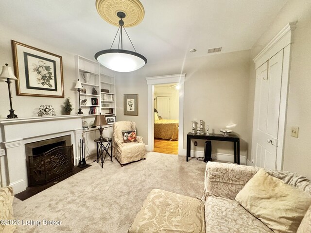 218 Locust St, Jeffersonville, IN 47130 - living room featuring carpet, a fireplace with flush hearth, and baseboards