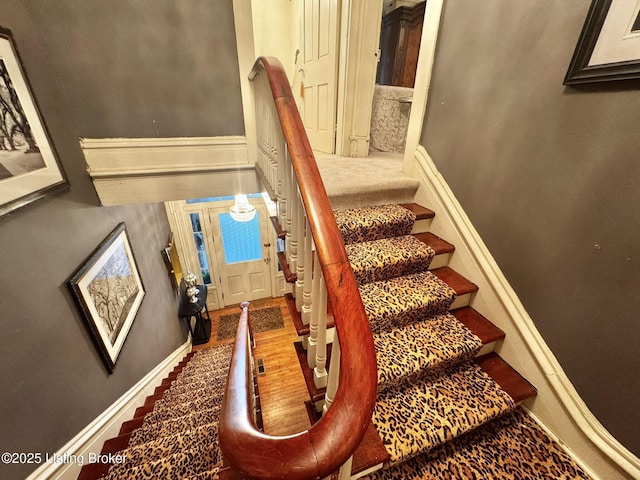 218 Locust St, Jeffersonville, IN 47130 - stairs featuring baseboards and wood finished floors