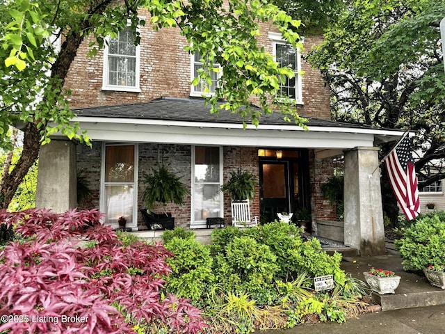218 Locust St, Jeffersonville, IN 47130 - view of front of property with covered porch and brick siding