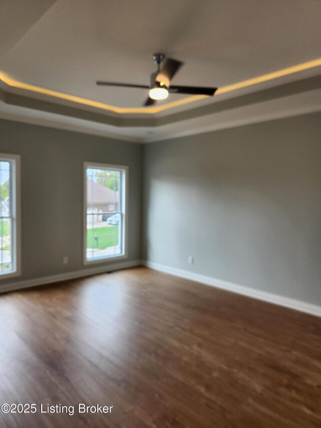 42 Lincoln Hill Way, Louisville, KY 40245 - empty room with a tray ceiling, wood finished floors, and baseboards