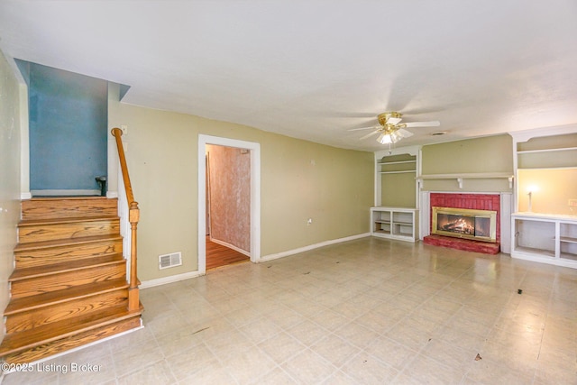 793 Samuels Loop, Coxs Creek, KY 40013 - unfurnished living room featuring ceiling fan, a brick fireplace, baseboards, and stairway