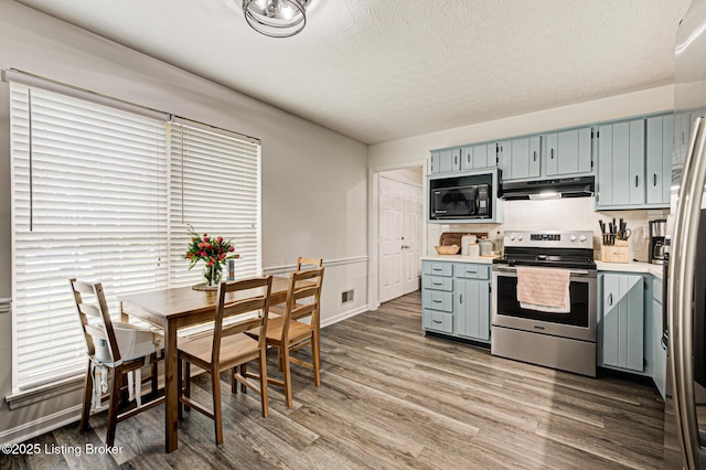 7020 Field View Ct, Louisville, KY 40291 - kitchen featuring stainless steel electric range, under cabinet range hood, black microwave, dark wood-style floors, and light countertops