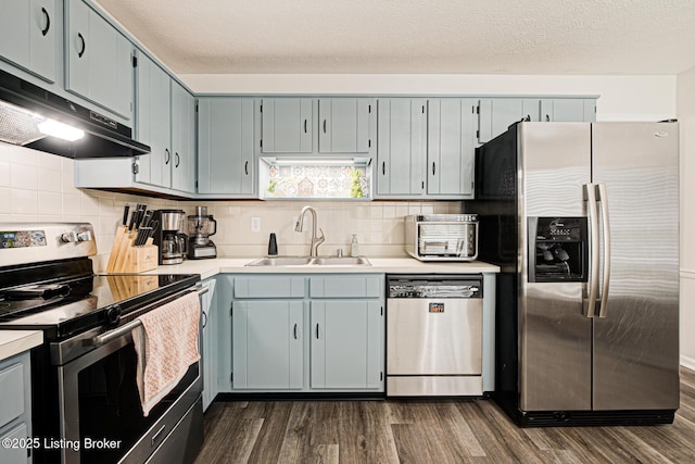 7020 Field View Ct, Louisville, KY 40291 - kitchen with stainless steel appliances, a sink, under cabinet range hood, dark wood-type flooring, and light countertops