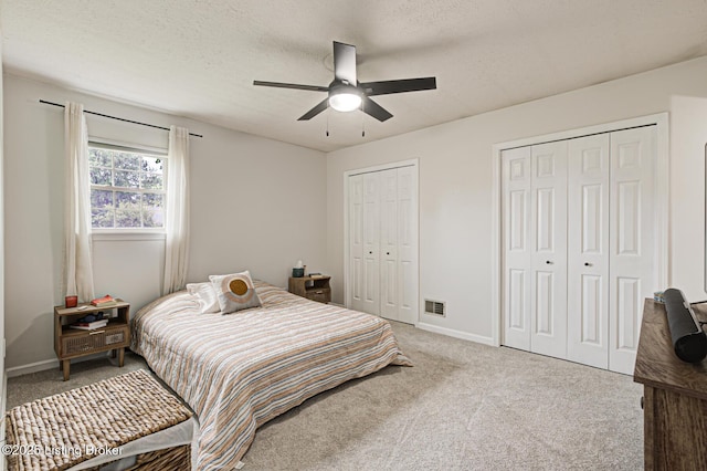 7020 Field View Ct, Louisville, KY 40291 - carpeted bedroom with two closets, baseboards, a textured ceiling, and a ceiling fan