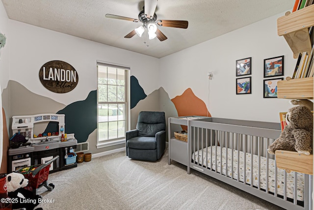 7020 Field View Ct, Louisville, KY 40291 - carpeted bedroom with a crib, a textured ceiling, ceiling fan, and baseboards