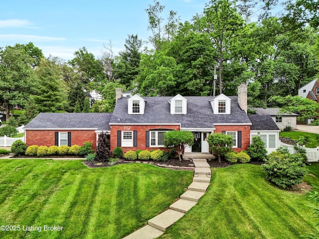 2501 Newburg Rd, Louisville, KY 40205 - cape cod home featuring a chimney, brick siding, view of wooded area, and a shingled roof