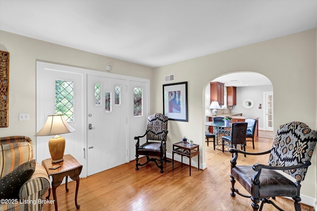 2501 Newburg Rd, Louisville, KY 40205 - foyer entrance with arched walkways, light wood-style floors, and baseboards