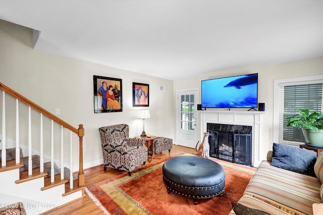 2501 Newburg Rd, Louisville, KY 40205 - living area with stairs, wood finished floors, a high end fireplace, and baseboards