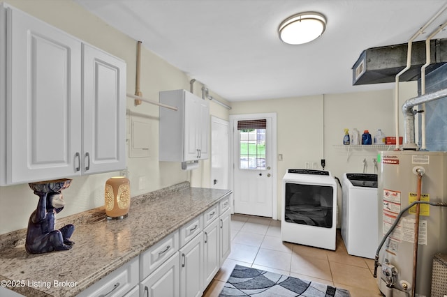 2501 Newburg Rd, Louisville, KY 40205 - laundry area with washer and clothes dryer, water heater, light tile patterned floors, and cabinet space