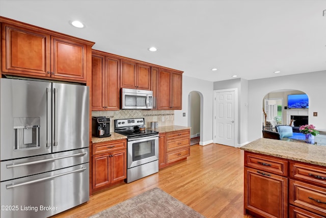 2501 Newburg Rd, Louisville, KY 40205 - kitchen featuring stainless steel appliances, arched walkways, recessed lighting, backsplash, and light wood-style floors