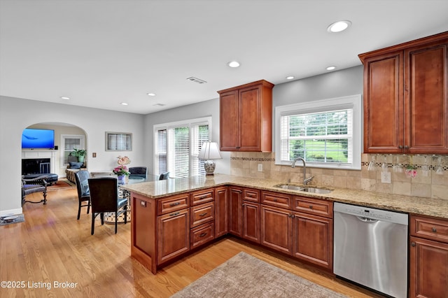 2501 Newburg Rd, Louisville, KY 40205 - kitchen with dishwasher, a sink, light wood finished floors, a peninsula, and arched walkways