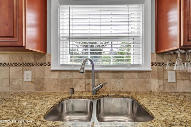 2501 Newburg Rd, Louisville, KY 40205 - kitchen featuring a sink, decorative backsplash, light stone counters, and reddish brown cabinets