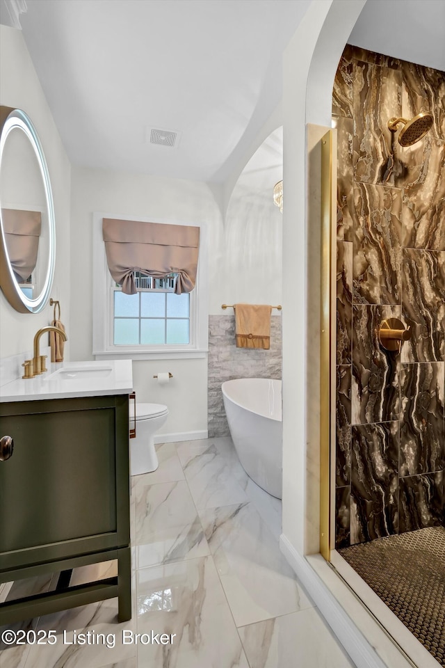 2501 Newburg Rd, Louisville, KY 40205 - bathroom featuring vanity, marble finish floors, a freestanding tub, toilet, and tiled shower