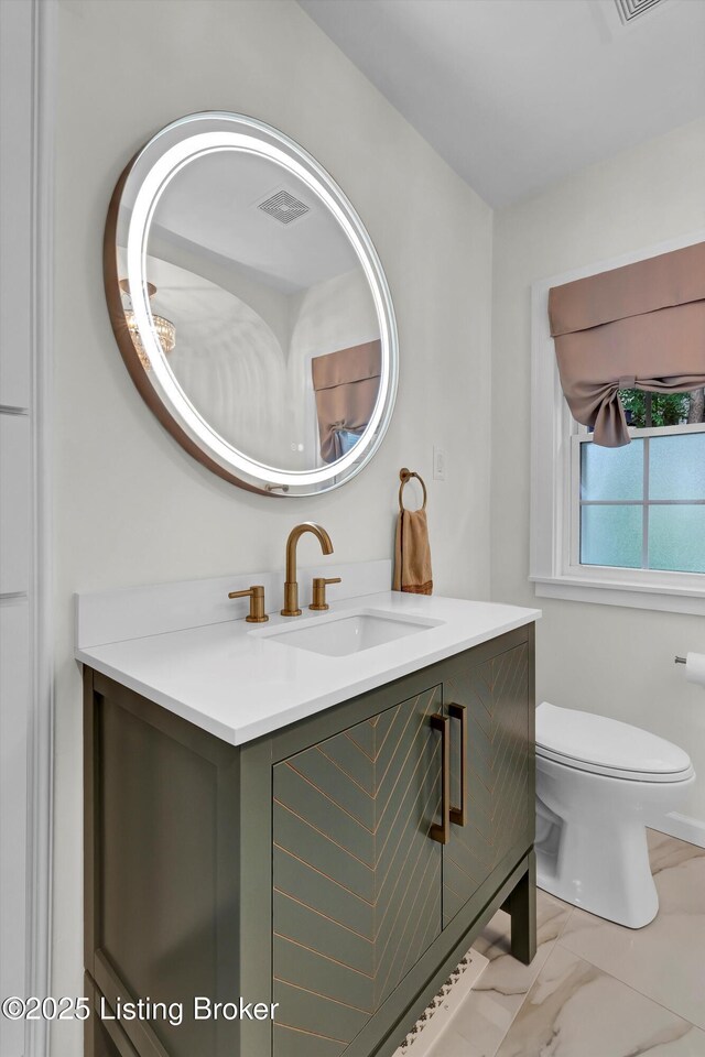 2501 Newburg Rd, Louisville, KY 40205 - bathroom featuring vanity, marble look tiles, and toilet