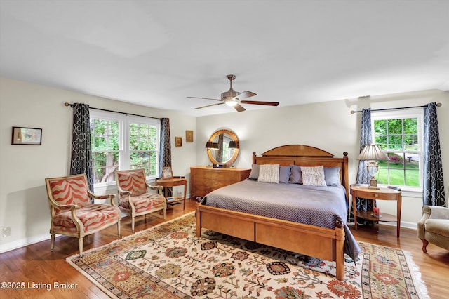 2501 Newburg Rd, Louisville, KY 40205 - bedroom featuring multiple windows, wood finished floors, a ceiling fan, and baseboards
