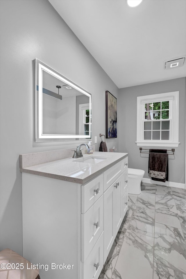 2501 Newburg Rd, Louisville, KY 40205 - bathroom featuring vanity, marble look tiles, and toilet