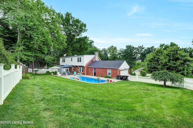 2501 Newburg Rd, Louisville, KY 40205 - back of house featuring brick siding, a chimney, view of scattered trees, and an attached garage
