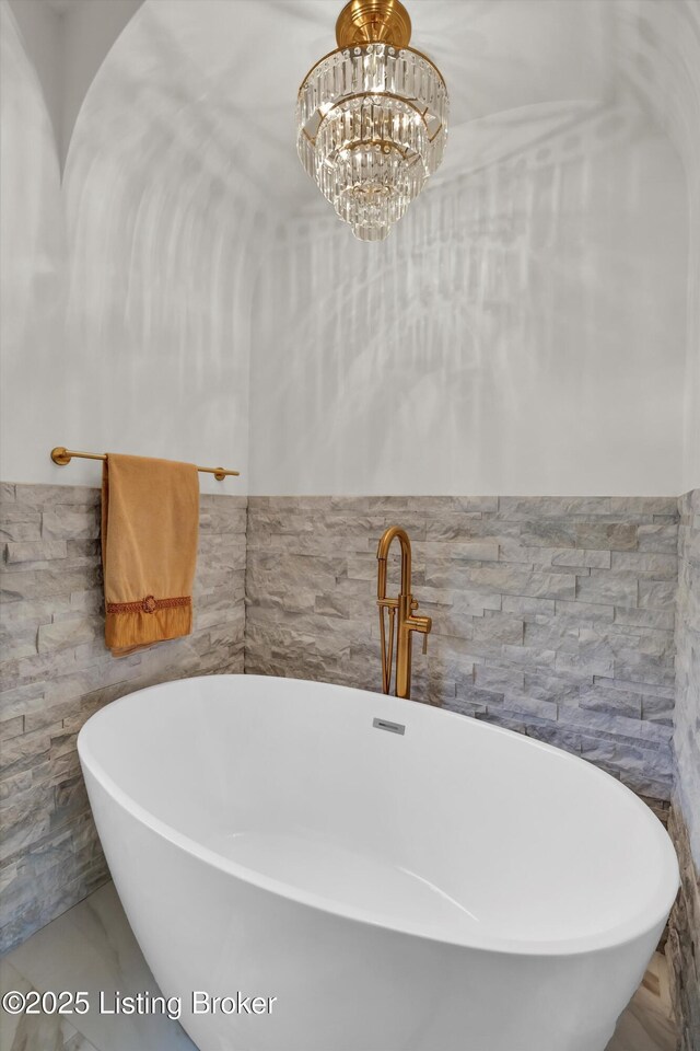 2501 Newburg Rd, Louisville, KY 40205 - bathroom featuring tile walls, a freestanding tub, and a chandelier