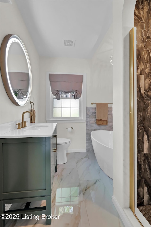 2501 Newburg Rd, Louisville, KY 40205 - full bath featuring a freestanding bath, vanity, marble finish floors, toilet, and a shower