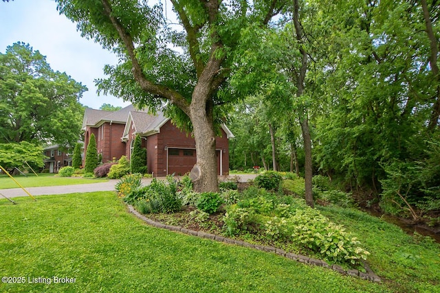 9200 Axminster Dr, Louisville, KY 40299 - view of front of house with a garage, driveway, and a front yard
