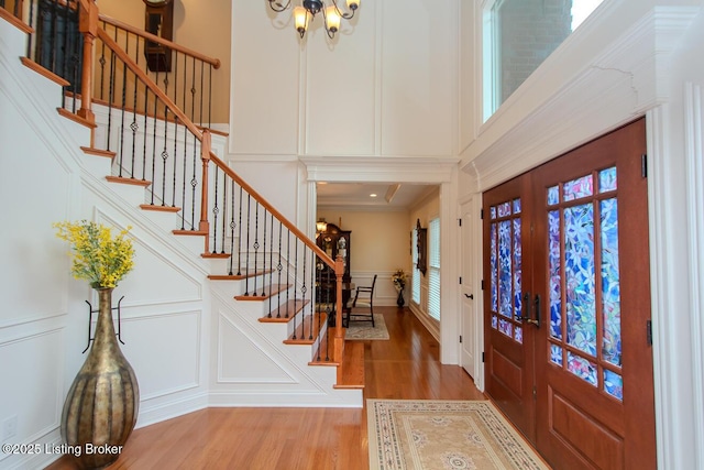 9200 Axminster Dr, Louisville, KY 40299 - entryway featuring a decorative wall, wood finished floors, stairway, french doors, and a chandelier