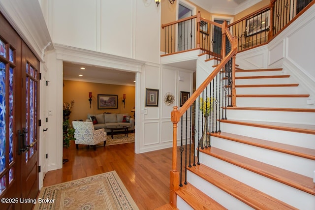 9200 Axminster Dr, Louisville, KY 40299 - foyer featuring a decorative wall, ornamental molding, wood finished floors, stairway, and french doors