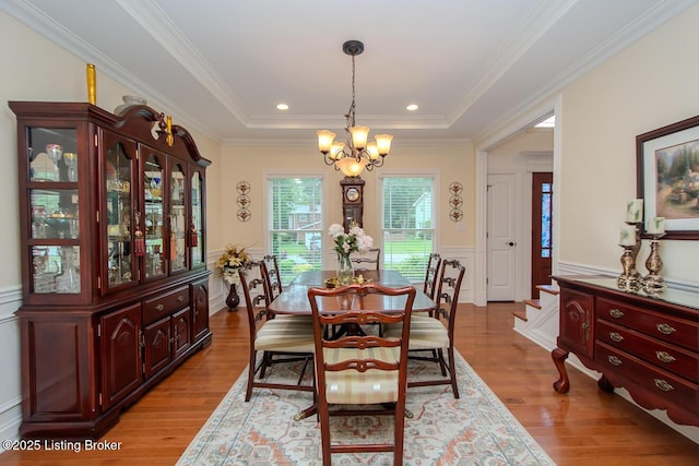 9200 Axminster Dr, Louisville, KY 40299 - dining room featuring a chandelier, wood finished floors, wainscoting, crown molding, and a raised ceiling