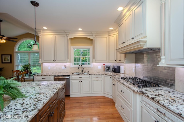 9200 Axminster Dr, Louisville, KY 40299 - kitchen with stainless steel appliances, a sink, ceiling fan, light wood finished floors, and light stone counters