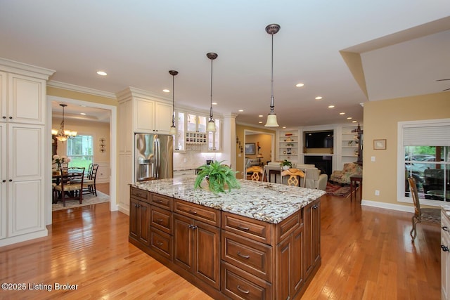 9200 Axminster Dr, Louisville, KY 40299 - kitchen with stainless steel fridge, white cabinetry, light wood-style floors, light stone countertops, and recessed lighting