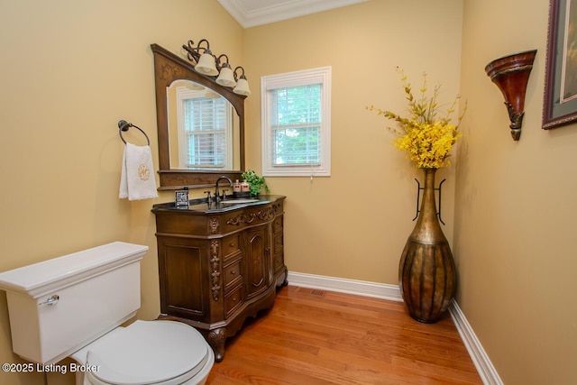 9200 Axminster Dr, Louisville, KY 40299 - half bath with toilet, wood finished floors, vanity, baseboards, and ornamental molding