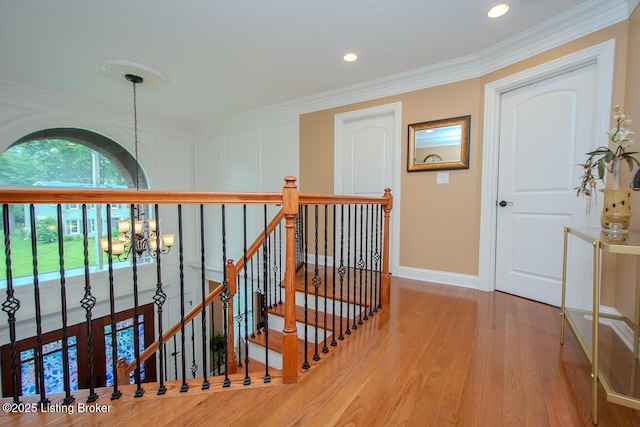 9200 Axminster Dr, Louisville, KY 40299 - corridor with a chandelier, an upstairs landing, wood finished floors, baseboards, and ornamental molding
