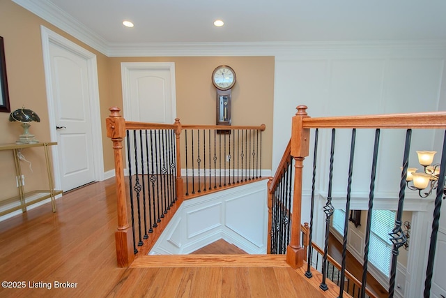 9200 Axminster Dr, Louisville, KY 40299 - stairway featuring wood finished floors, ornamental molding, a decorative wall, and recessed lighting