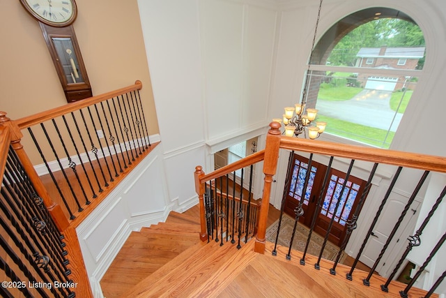 9200 Axminster Dr, Louisville, KY 40299 - stairway featuring a decorative wall, a chandelier, and wood finished floors