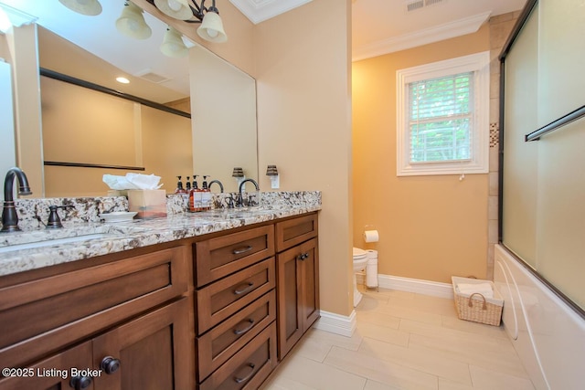 9200 Axminster Dr, Louisville, KY 40299 - bathroom with crown molding, double vanity, toilet, combined bath / shower with glass door, and baseboards