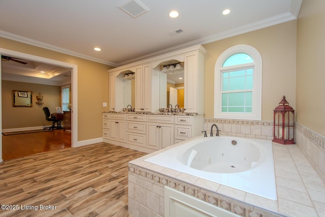 9200 Axminster Dr, Louisville, KY 40299 - bathroom with a whirlpool tub, double vanity, ornamental molding, wood finished floors, and recessed lighting