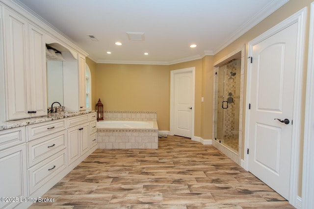 9200 Axminster Dr, Louisville, KY 40299 - full bath featuring wood finished floors, a bath, recessed lighting, a shower stall, and vanity