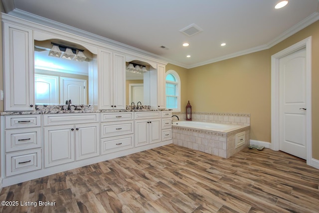 9200 Axminster Dr, Louisville, KY 40299 - full bath featuring double vanity, a garden tub, ornamental molding, wood finished floors, and recessed lighting