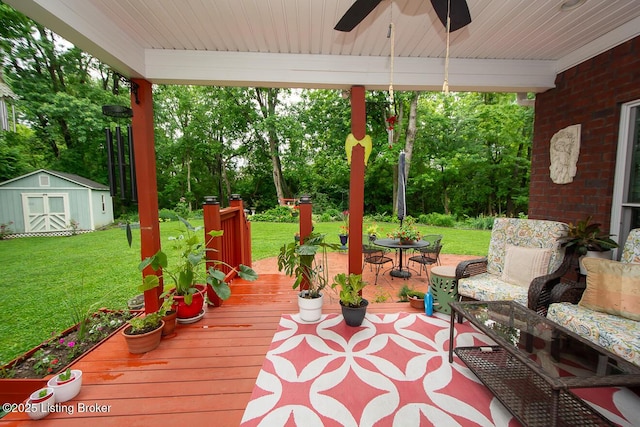 9200 Axminster Dr, Louisville, KY 40299 - wooden deck with a lawn, a ceiling fan, and view of scattered trees