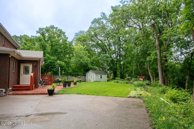 9200 Axminster Dr, Louisville, KY 40299 - view of yard with a patio, a wooden deck, and view of wooded area
