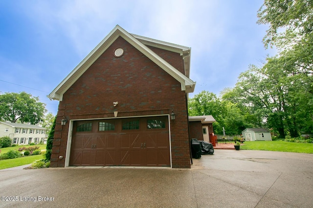9200 Axminster Dr, Louisville, KY 40299 - garage featuring concrete driveway and a storage shed