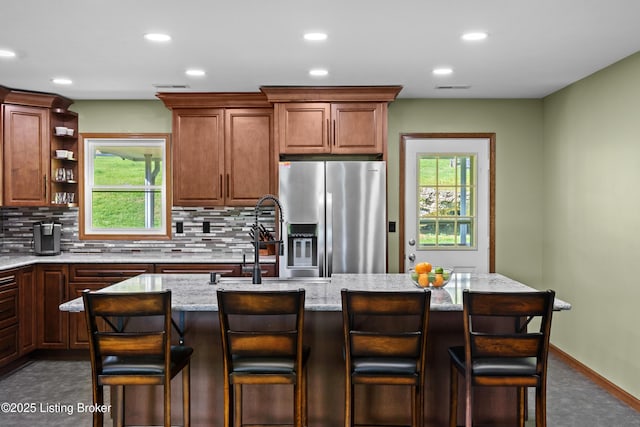 1415 Zoneton Rd, Shepherdsville, KY 40165 - kitchen featuring stainless steel fridge, decorative backsplash, recessed lighting, plenty of natural light, and light stone counters