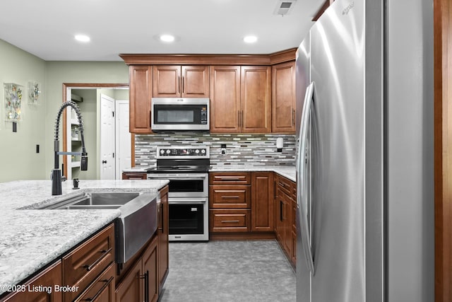 1415 Zoneton Rd, Shepherdsville, KY 40165 - kitchen with appliances with stainless steel finishes, a sink, decorative backsplash, light stone counters, and recessed lighting