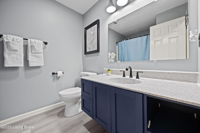 1415 Zoneton Rd, Shepherdsville, KY 40165 - bathroom featuring vanity, wood finished floors, toilet, baseboards, and curtained shower