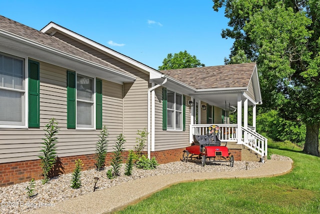 1415 Zoneton Rd, Shepherdsville, KY 40165 - view of property exterior featuring a porch, roof with shingles, and a yard