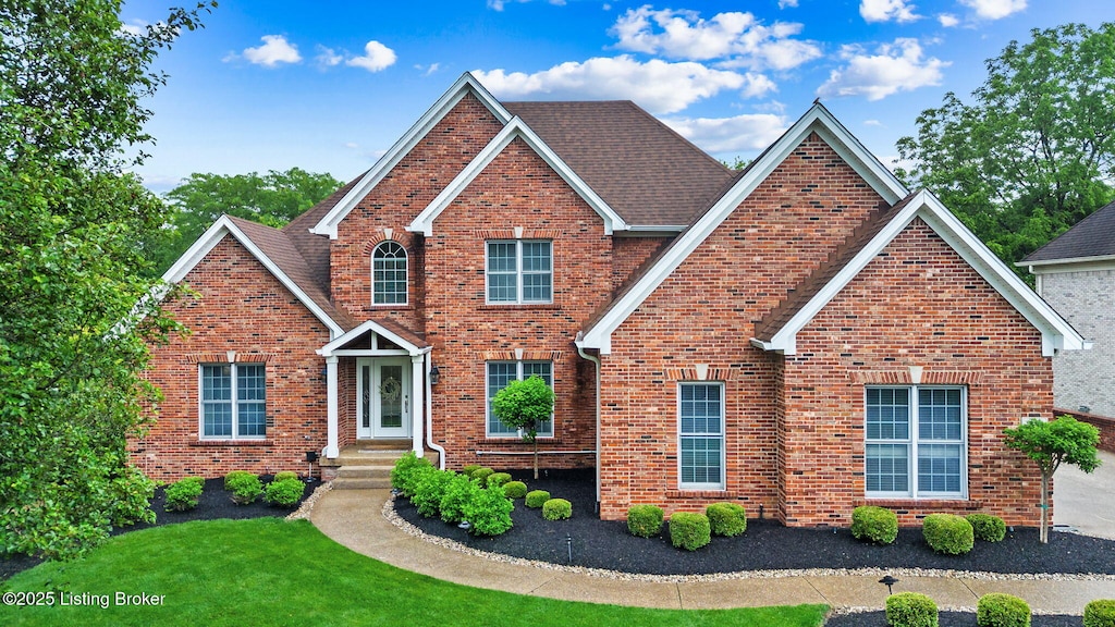 311 Shallowford Pl, Louisville, KY 40245 - traditional home featuring brick siding, a front lawn, and a shingled roof