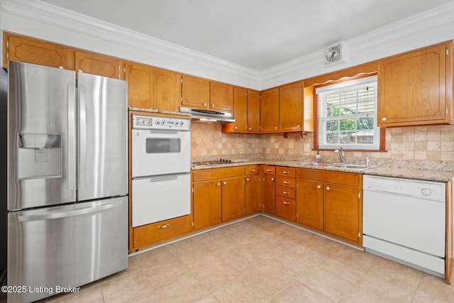 4011 White Plains Ct, Louisville, KY 40218 - kitchen with white appliances, under cabinet range hood, ornamental molding, and brown cabinetry